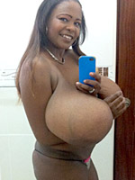 Smily black girlfriend slowly stripping off her undies and making xxx selfshot pics of her huge tits.